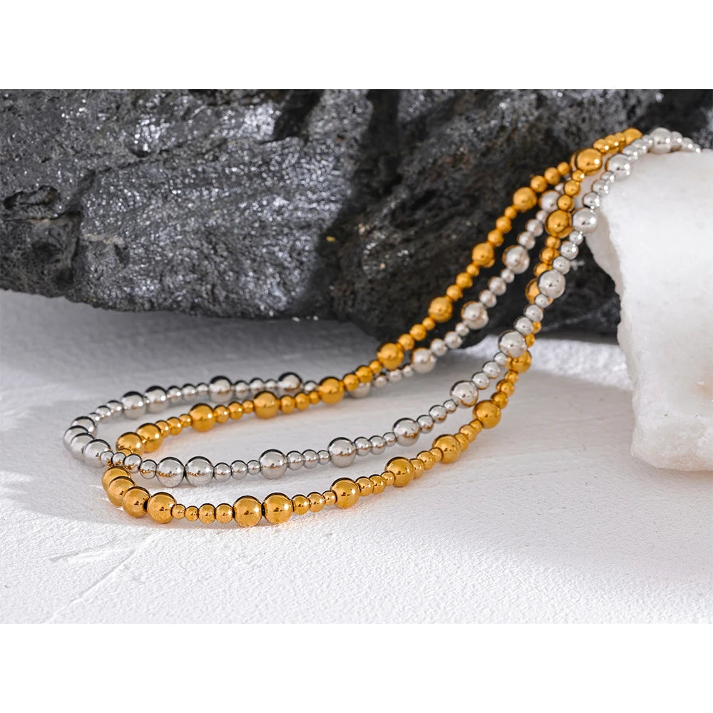 Beaded geometric chain necklace in gold-plated stainless steel.