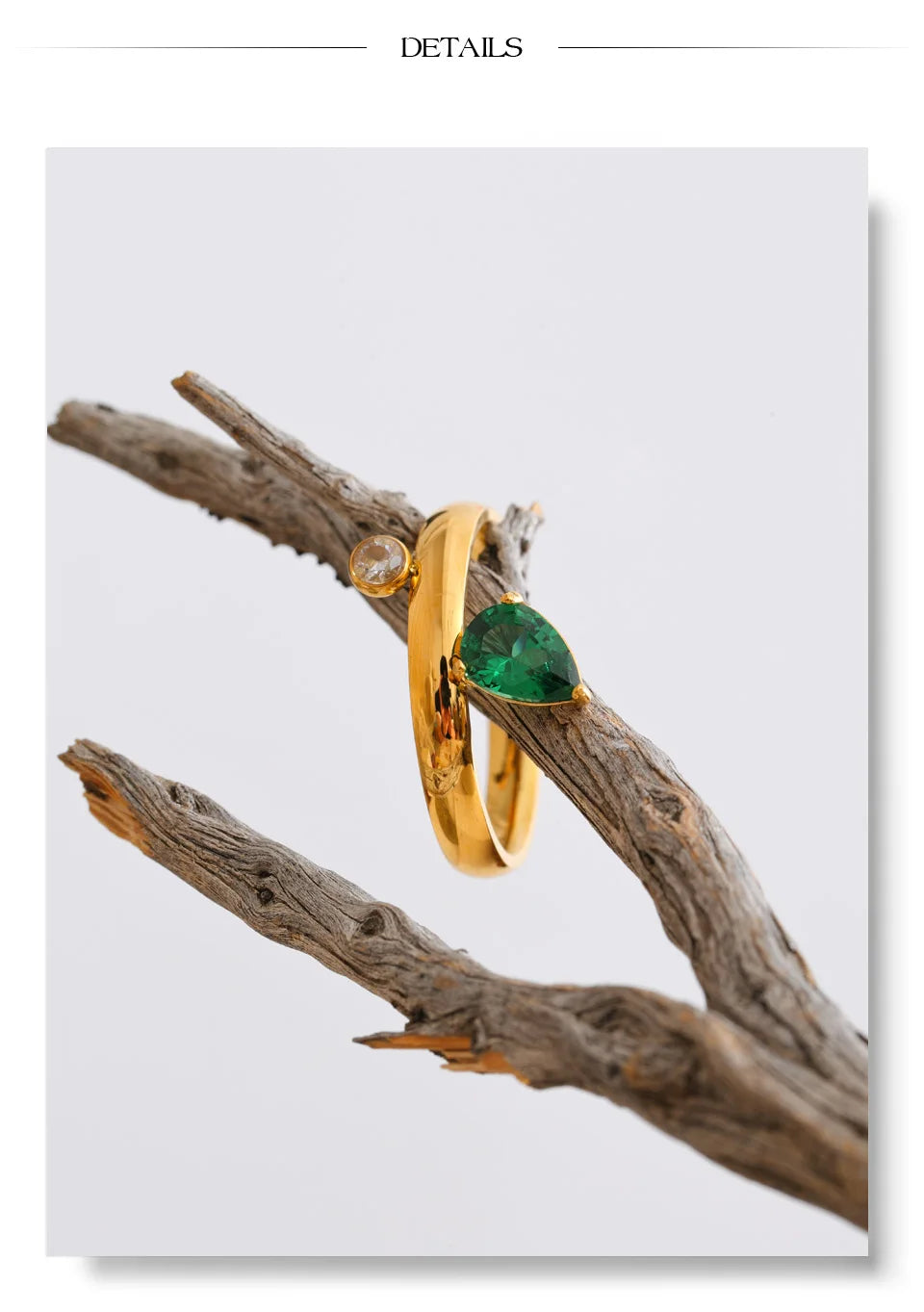 Green cubic zirconia geometric ring in 18K gold-plated stainless steel with cubic zirconia.
