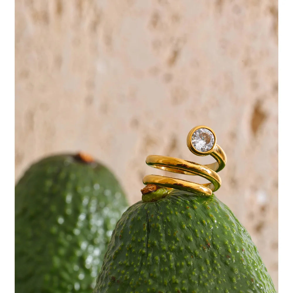Cubic zirconia geometric layered ring in 18K gold-plated stainless steel with cubic zirconia.