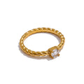 Cubic zirconia geometric ring in 18K gold-plated stainless steel with cubic zirconia.