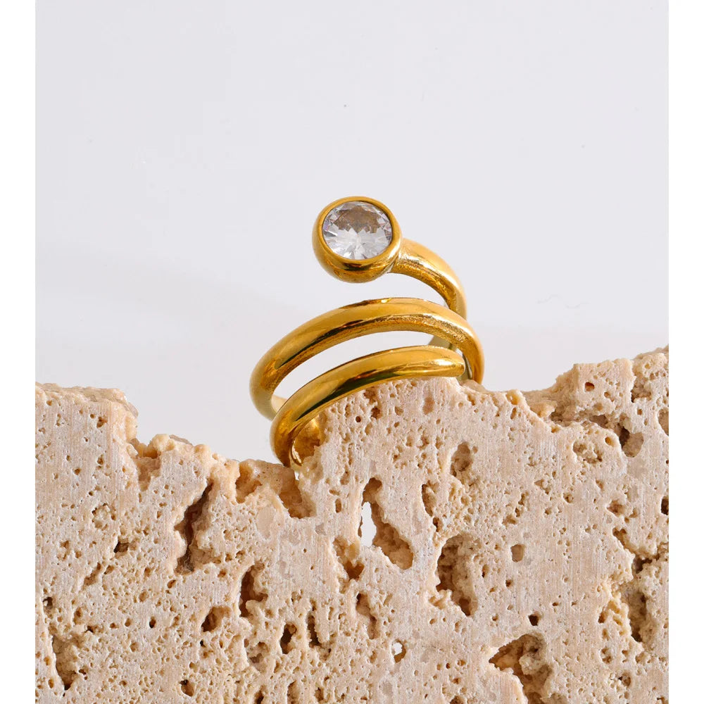 Cubic zirconia geometric layered ring in 18K gold-plated stainless steel with cubic zirconia.