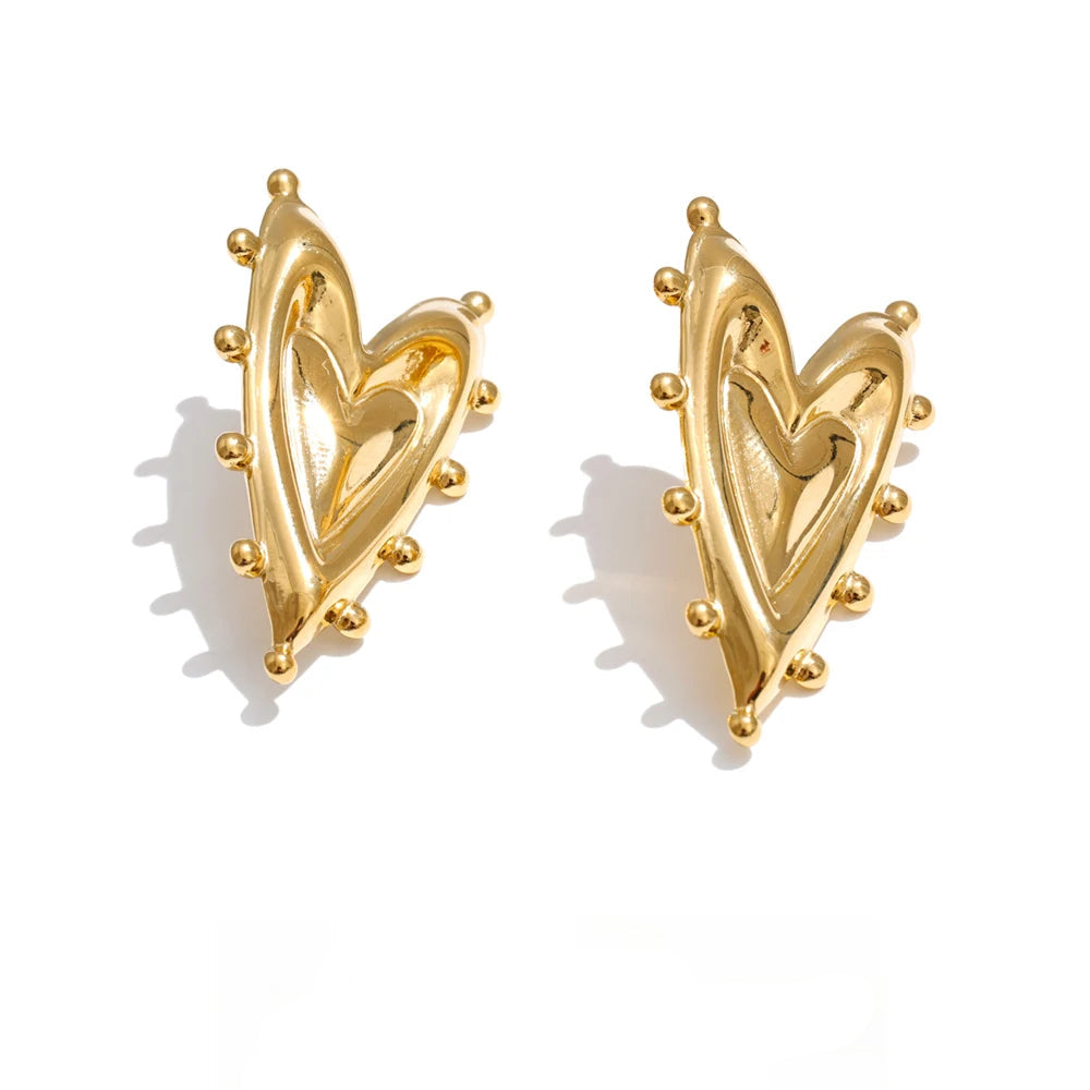 Gold-plated stainless steel heart earrings with a small bead detailing the outline of the heart.