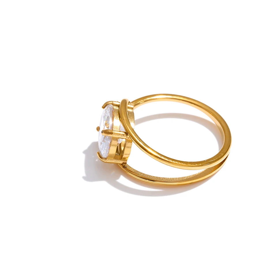 Cubic zirconia geometric ring in 18K gold-plated stainless steel with cubic zirconia.
