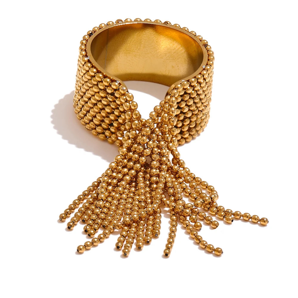 Gold-plated stainless steel ring with tassel detail.