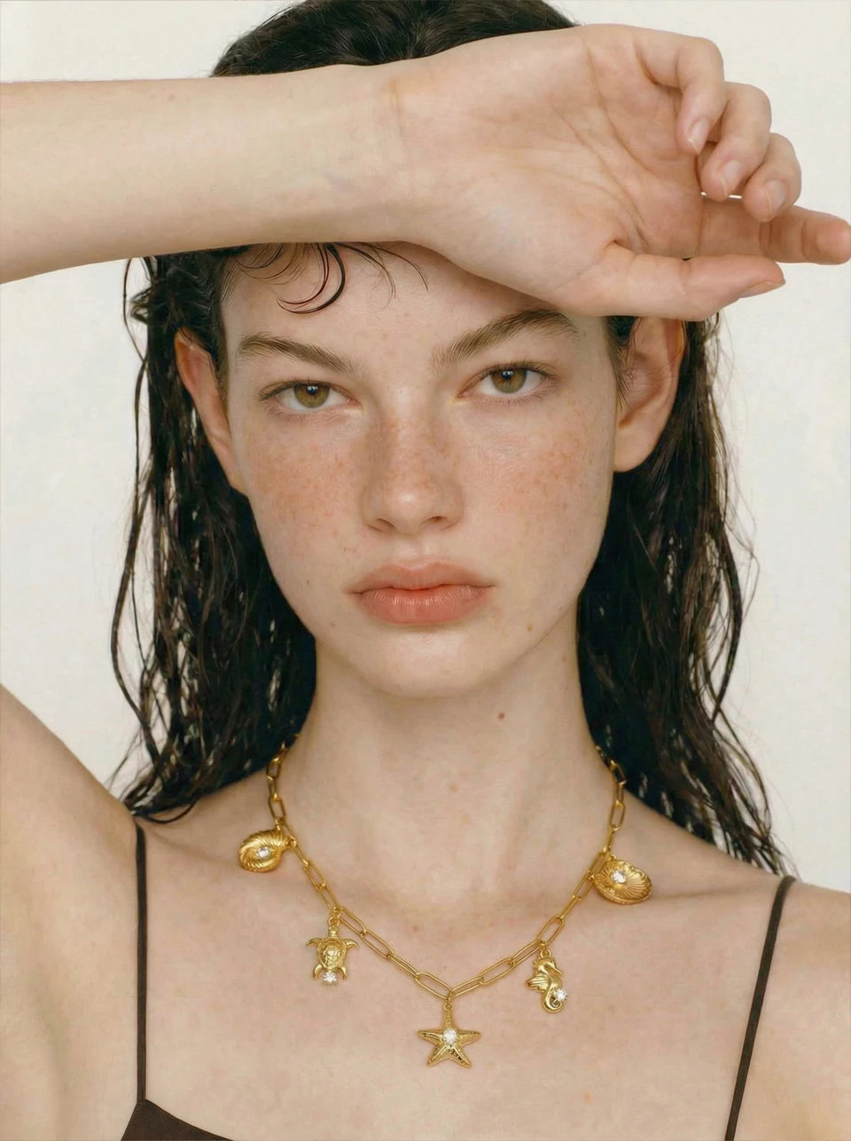 Cubic zirconia shell star necklace in gold-plated stainless steel with cubic zirconia and shell.