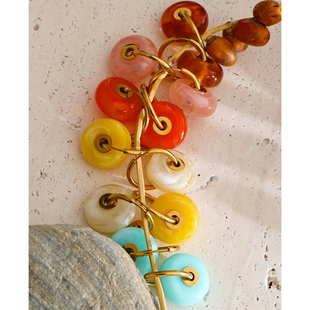 Resin acrylic geometric earrings in gold-plated stainless steel with resin and acrylic.