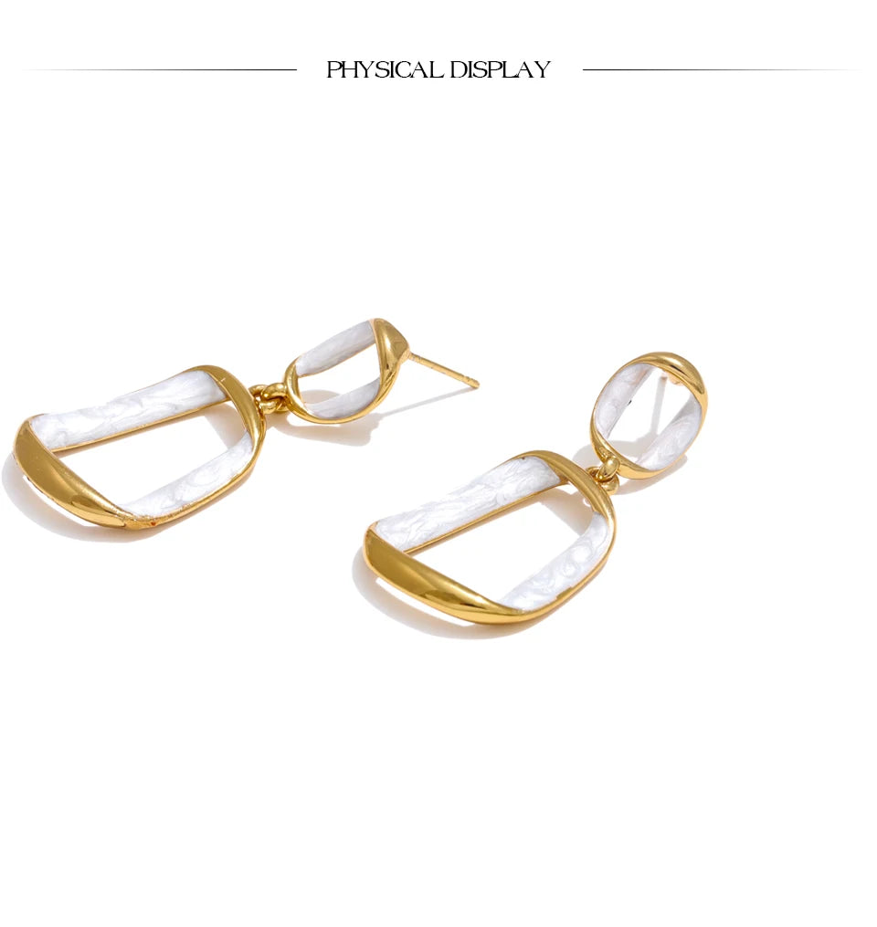 White enamel geometric earrings in gold-plated stainless steel with enamel.