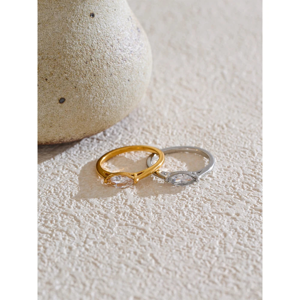 Cubic zirconia geometric ring in 18K gold-plated stainless steel with cubic zirconia.