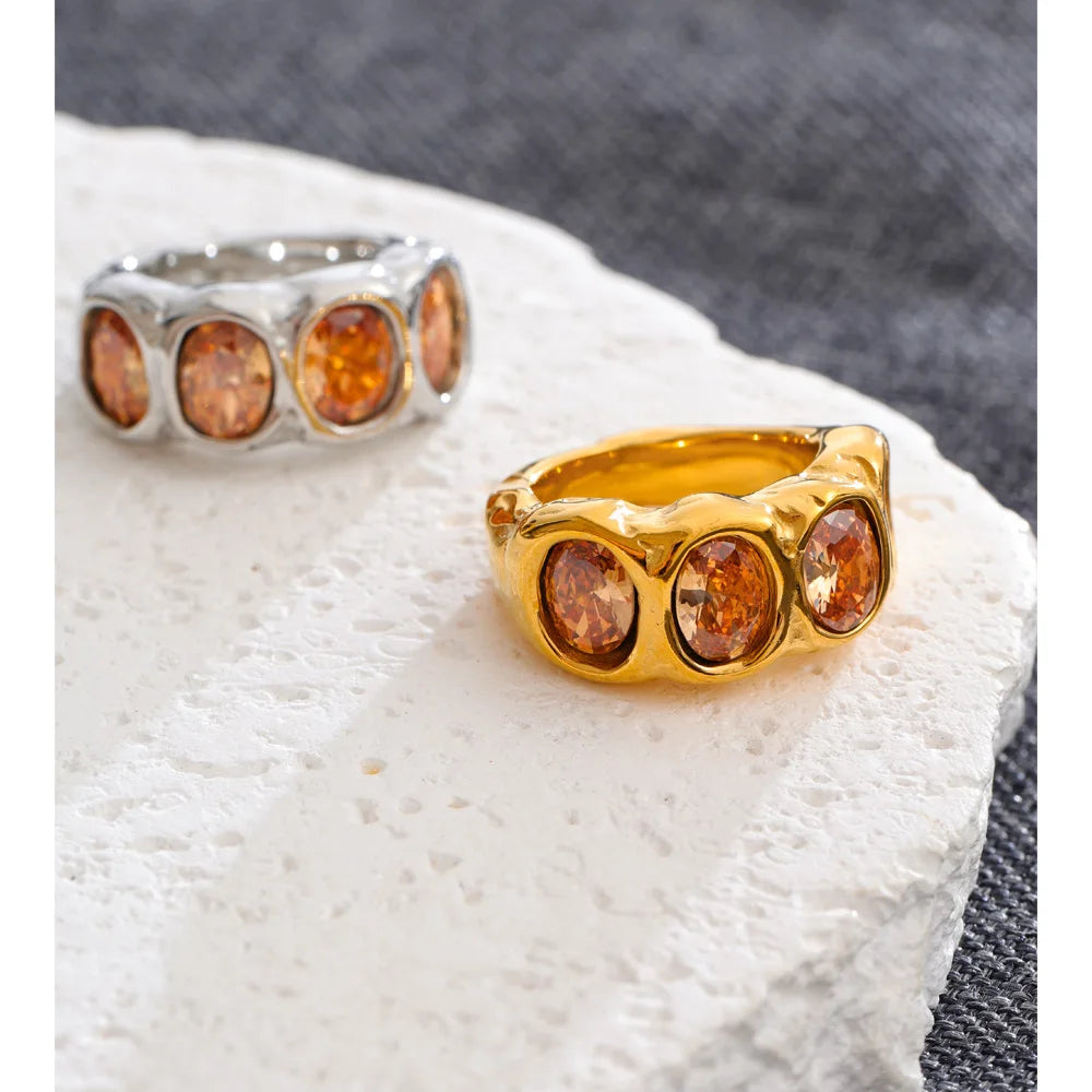 Cubic zirconia geometric ring in 18K gold-plated stainless steel with cubic zirconia.