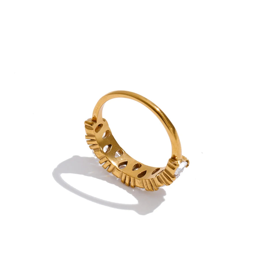 Cubic zirconia geometric ring in 18K gold-plated stainless steel with cubic zirconia.