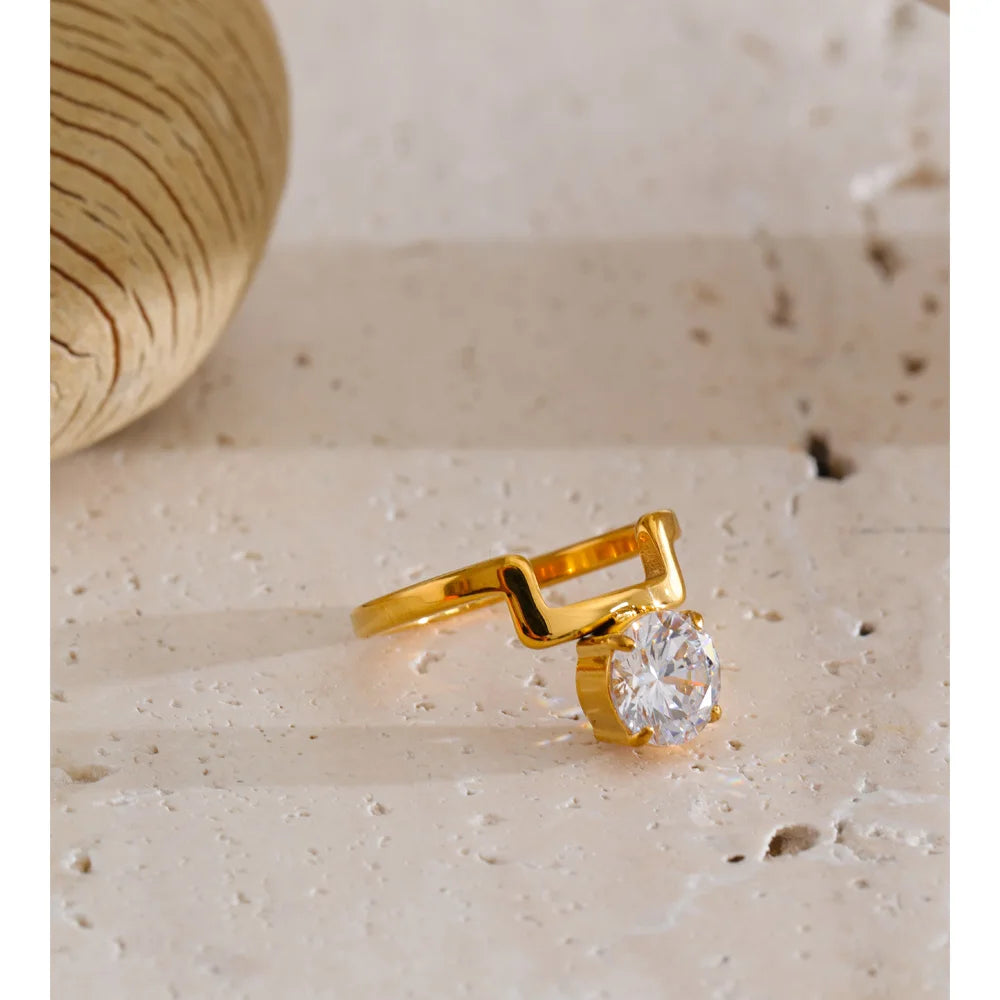Cubic zirconia geometric ring in 18K gold-plated stainless steel with cubic zirconia.