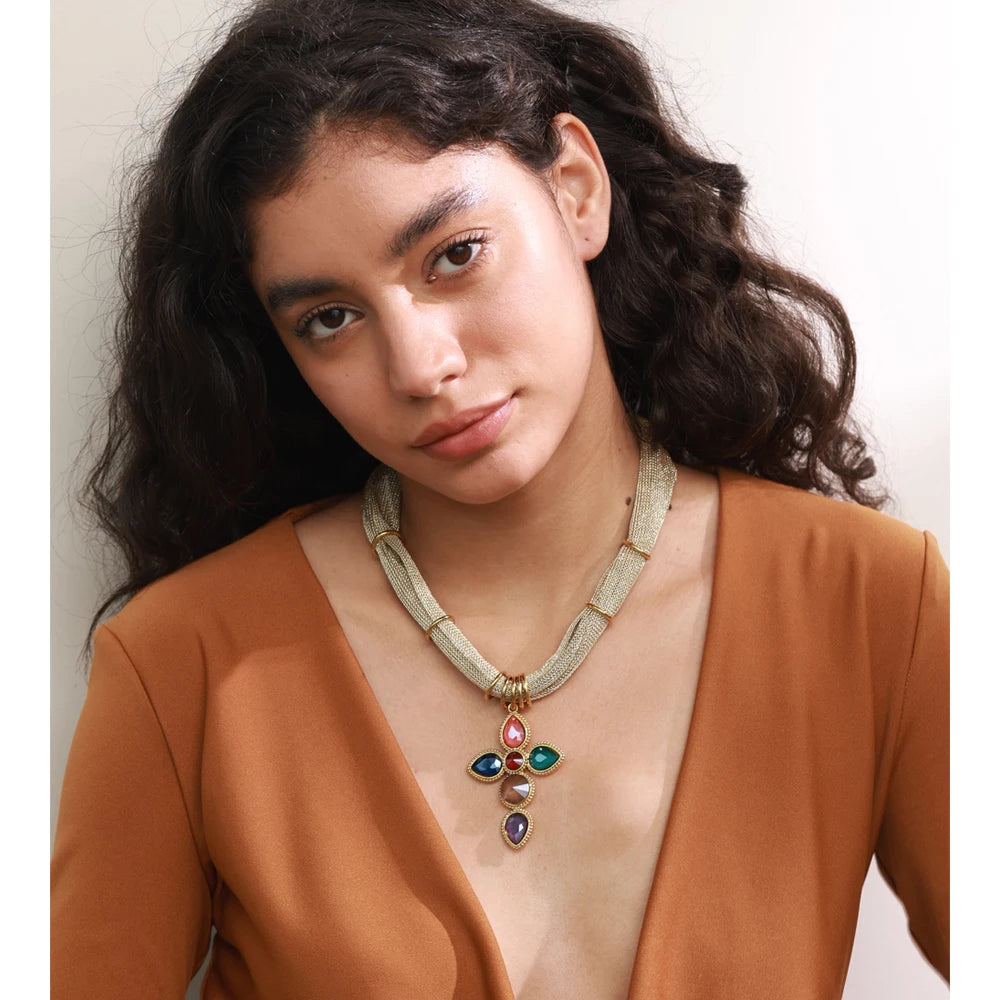 White glass cross necklace in gold-plated stainless steel.