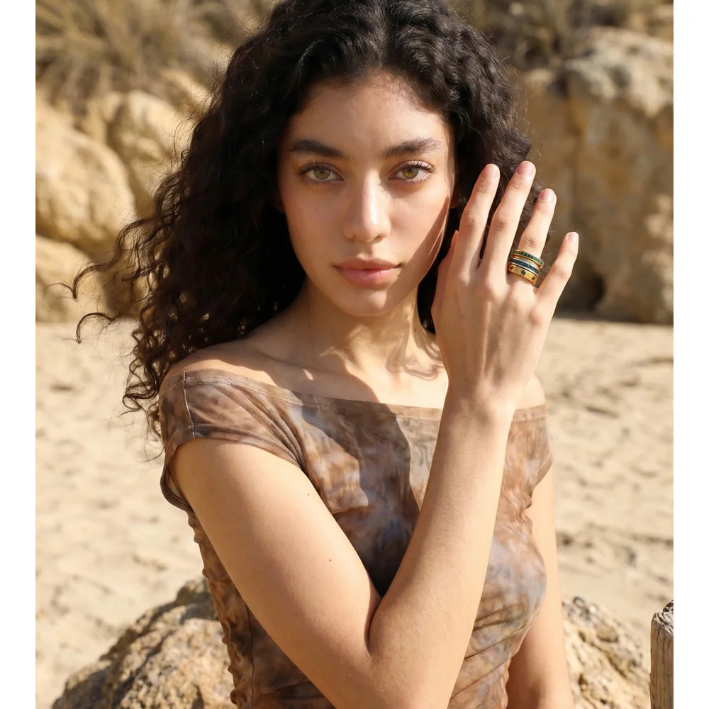 White cubic zirconia geometric ring in 18K gold-plated stainless steel with cubic zirconia.