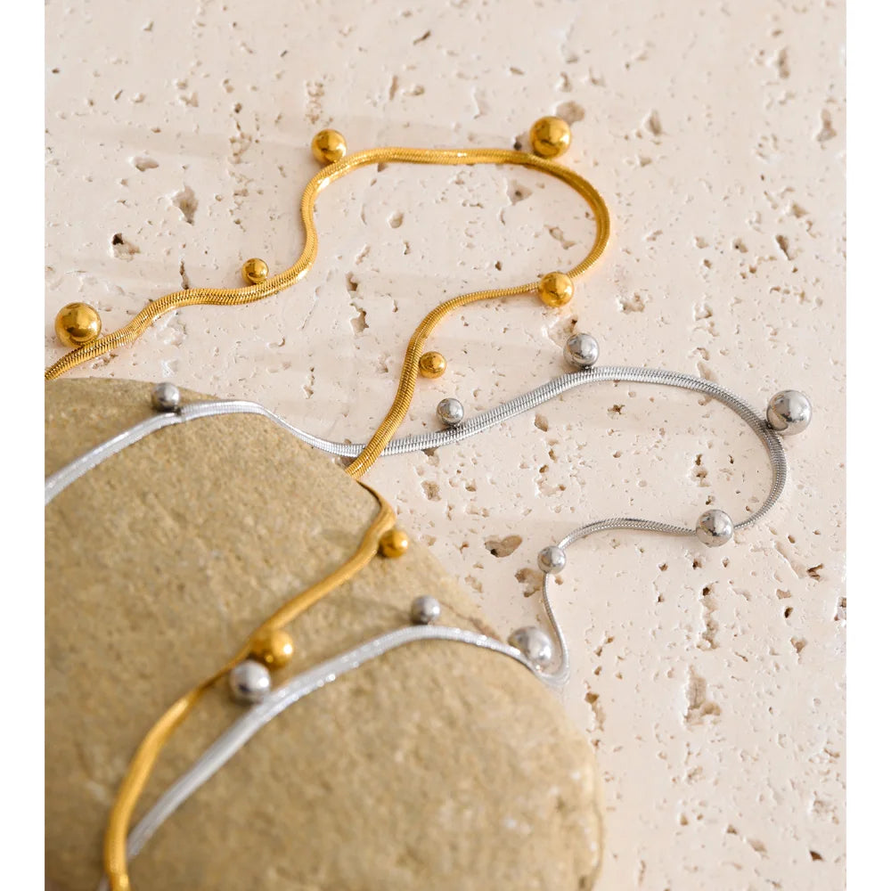 Beaded geometric chain necklace in gold-plated stainless steel.