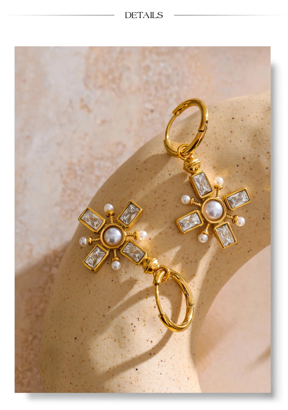 Cubic zirconia pearl cross earrings in gold-plated stainless steel with pearl and cubic zirconia.