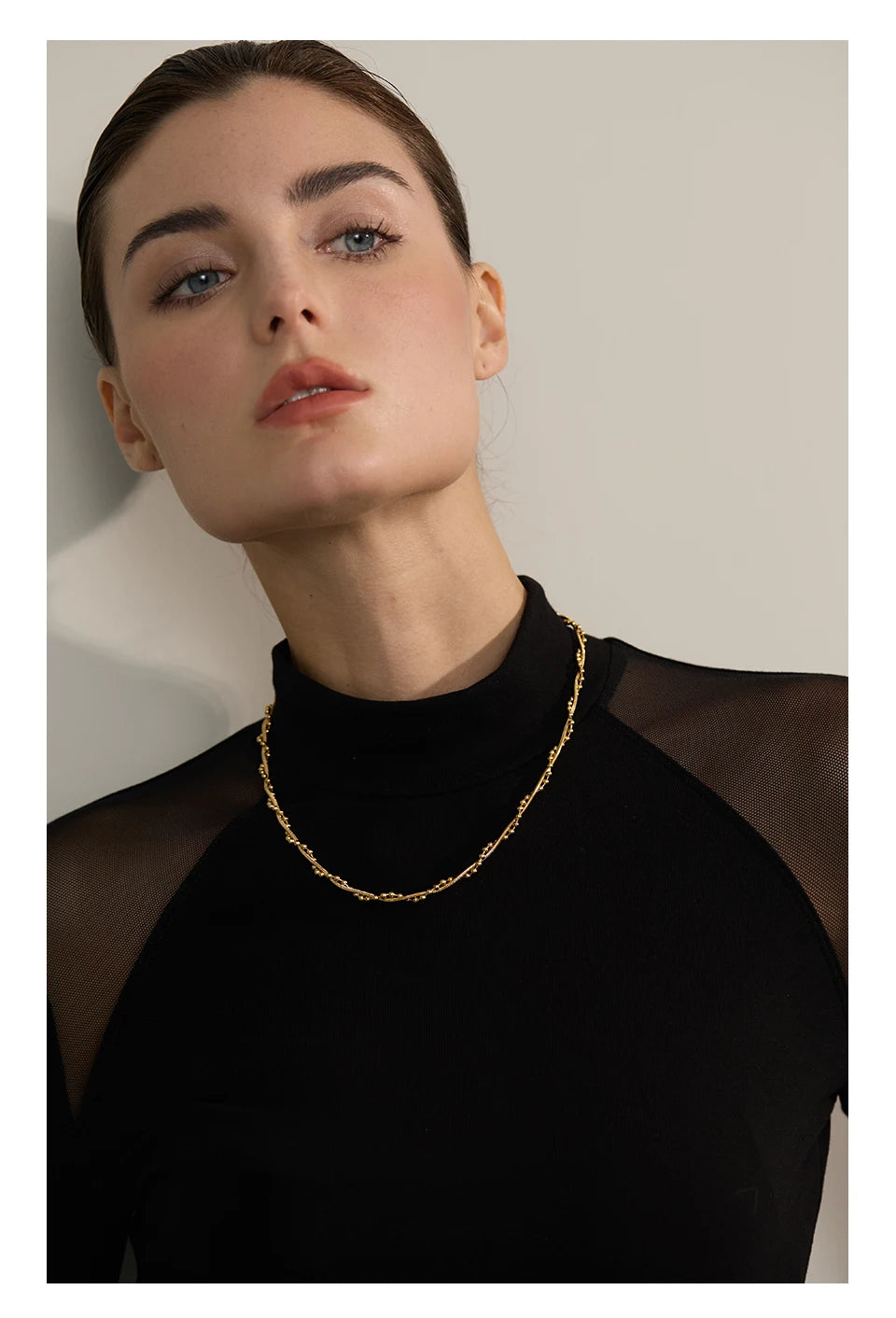 Geometric chain necklace in gold-plated stainless steel.