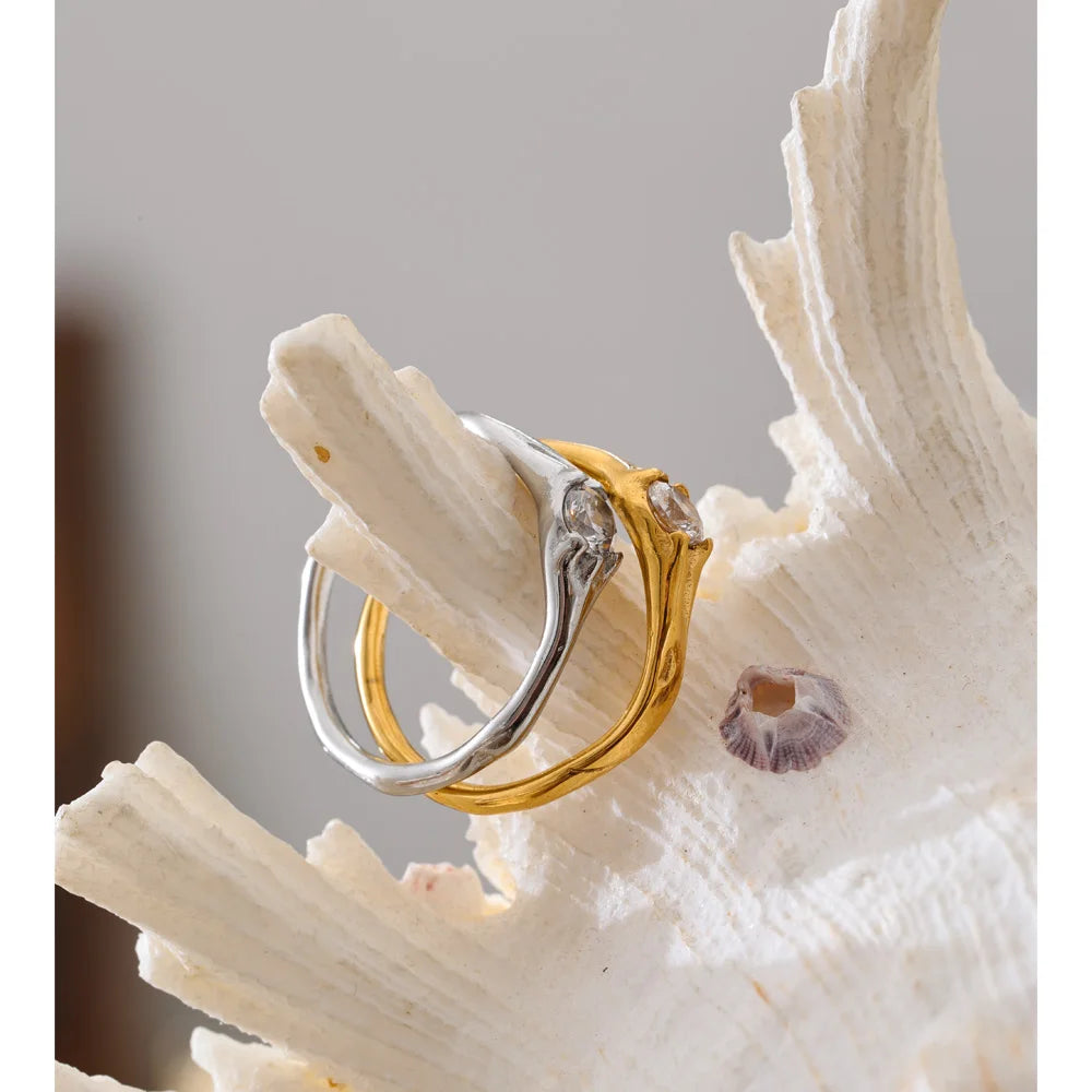 Cubic zirconia geometric ring in 18K gold-plated stainless steel with cubic zirconia.