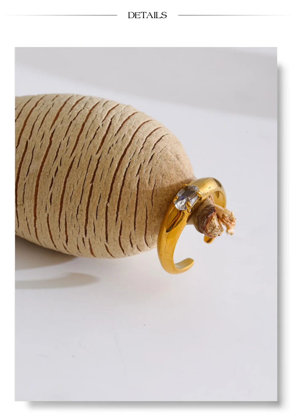 Cubic zirconia geometric ring in 18K gold-plated stainless steel with cubic zirconia.