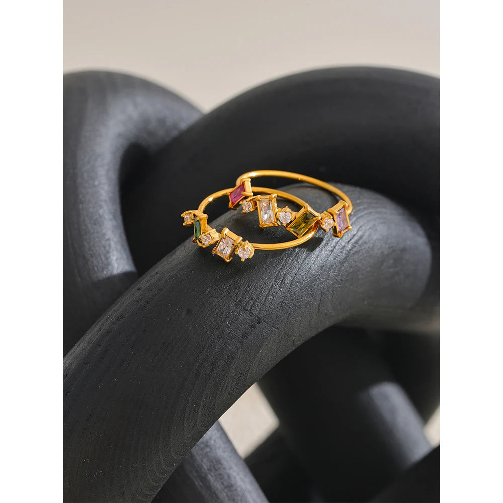 Cubic zirconia multi-color geometric ring in 18K gold-plated stainless steel with cubic zirconia.