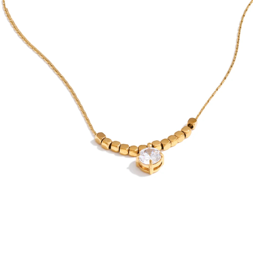 Cubic zirconia beaded geometric necklace in gold-plated stainless steel with cubic zirconia.