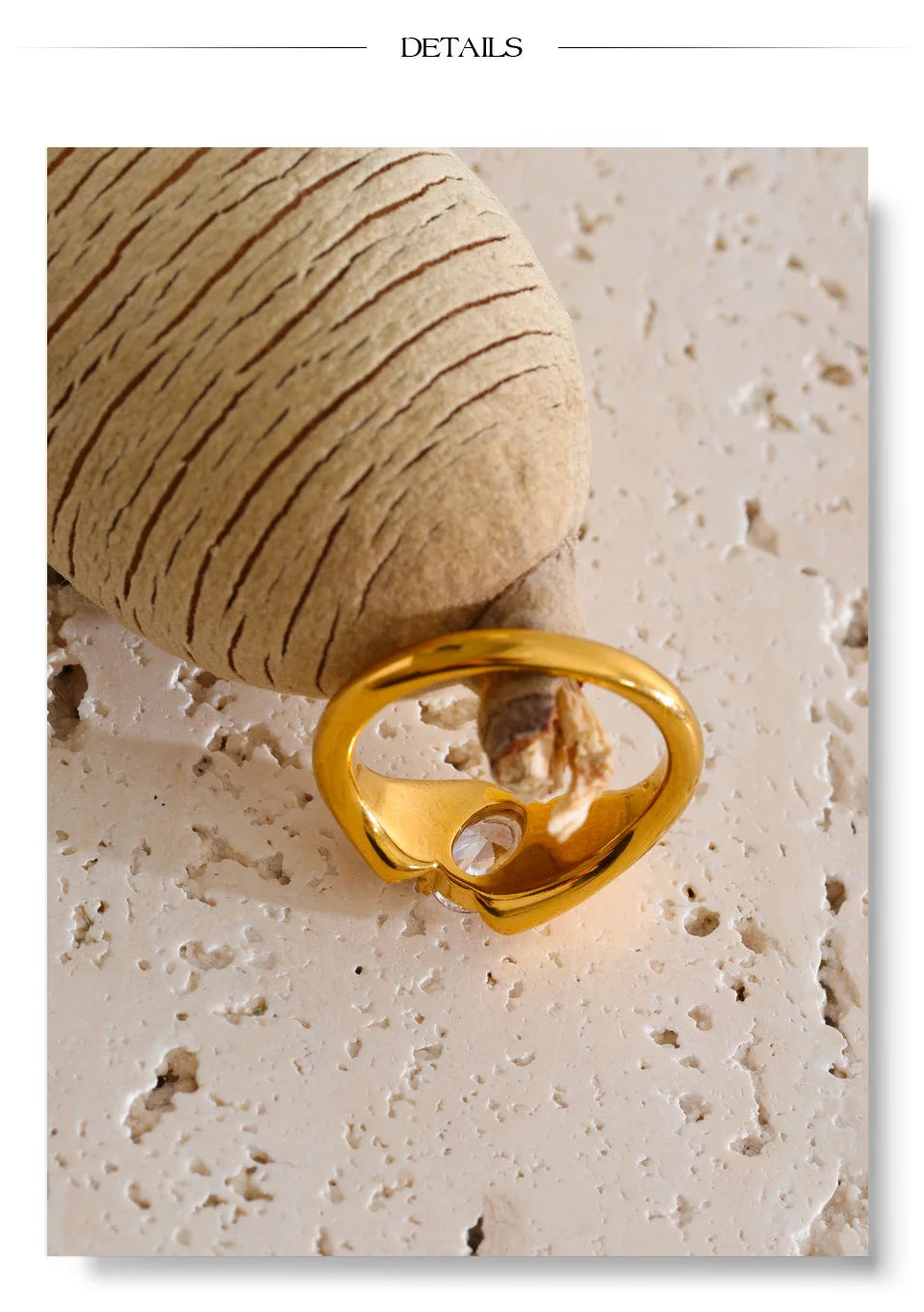 Cubic zirconia geometric ring in 18K gold-plated stainless steel with cubic zirconia.