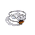 Cubic zirconia natural stone geometric ring in 18K gold-plated stainless steel with cubic zirconia and natural stone.