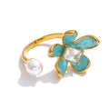 Cubic zirconia enamel flower ring in gold-plated stainless steel with cubic zirconia and enamel.
