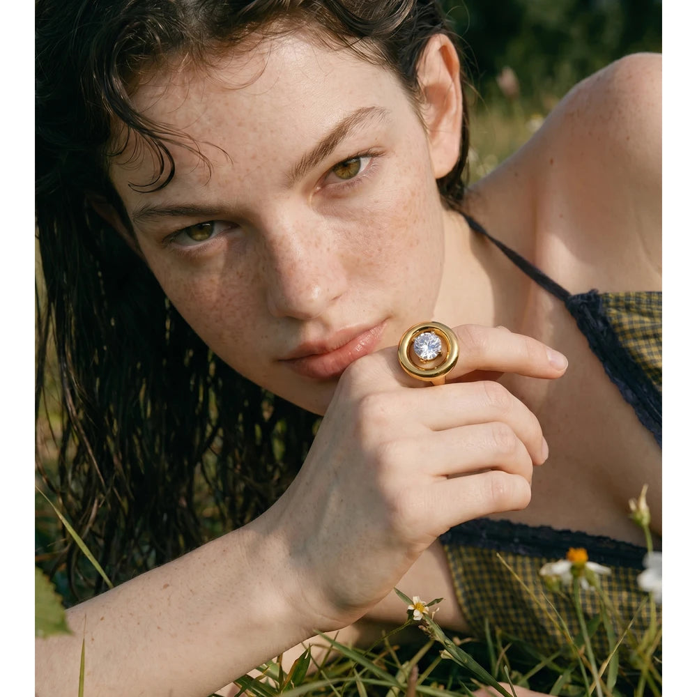 Cubic zirconia geometric ring in 18K gold-plated stainless steel with cubic zirconia.