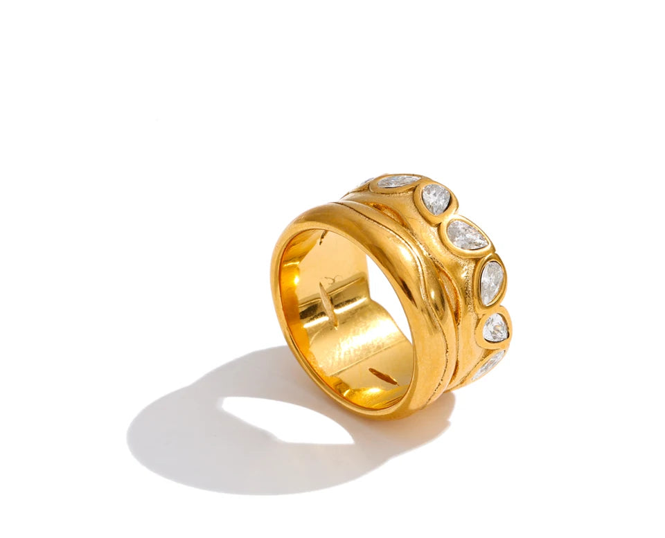 Cubic zirconia geometric ring in 18K gold-plated stainless steel with cubic zirconia.