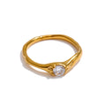 Cubic zirconia geometric ring in 18K gold-plated stainless steel with cubic zirconia.
