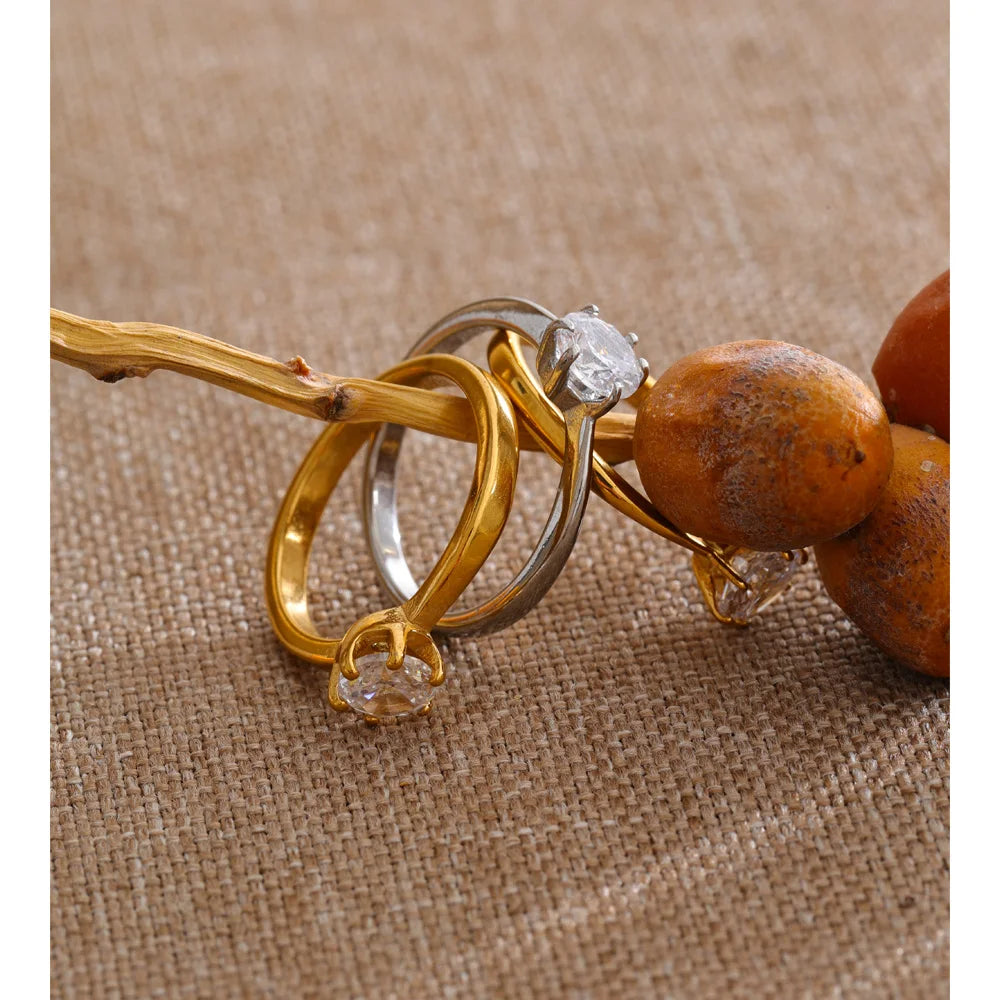 Cubic zirconia geometric ring in 18K gold-plated stainless steel with cubic zirconia.