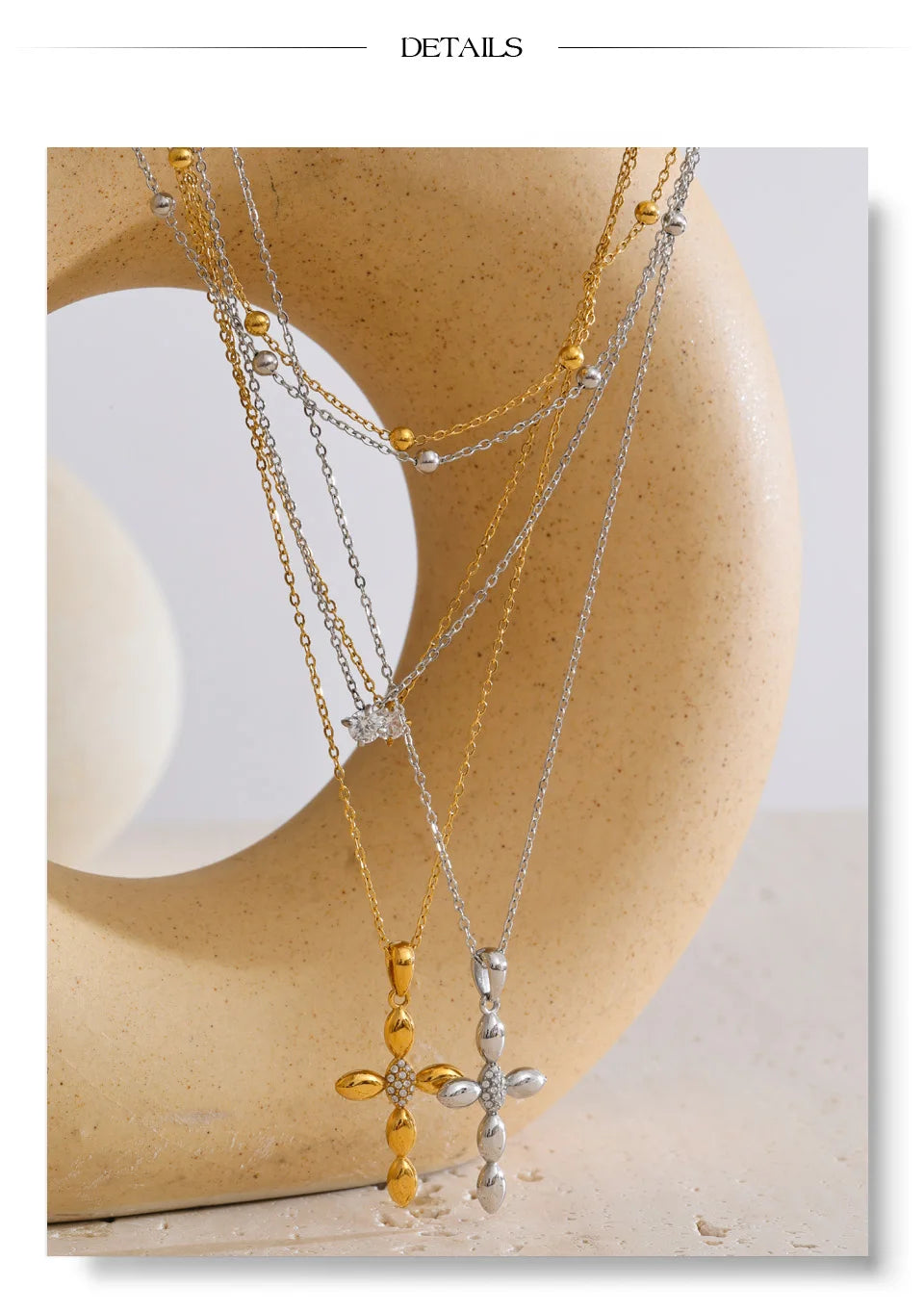 Cubic zirconia cross chain necklace in gold-plated stainless steel with cubic zirconia.