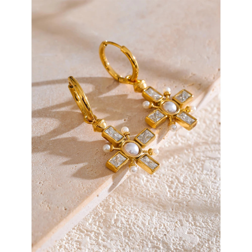 Cubic zirconia pearl cross earrings in gold-plated stainless steel with pearl and cubic zirconia.