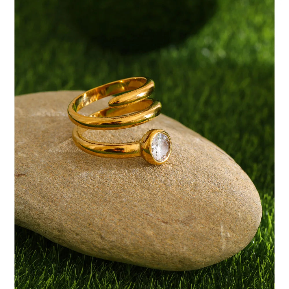 Cubic zirconia geometric layered ring in 18K gold-plated stainless steel with cubic zirconia.