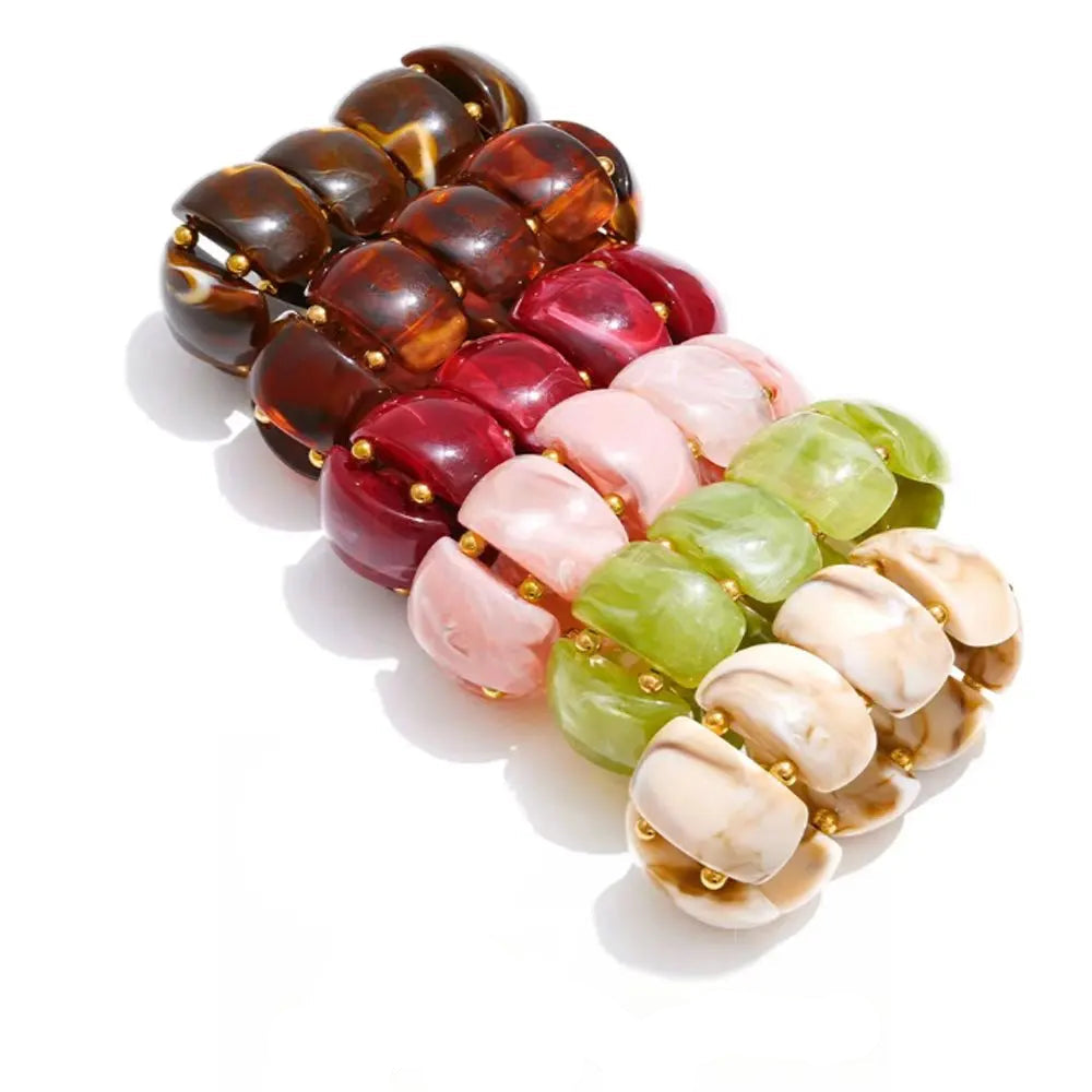Bracelet made of gold-plated stainless steel with resin beads in various colors.