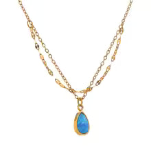 Gold-plated necklace with blue stone pendant.
