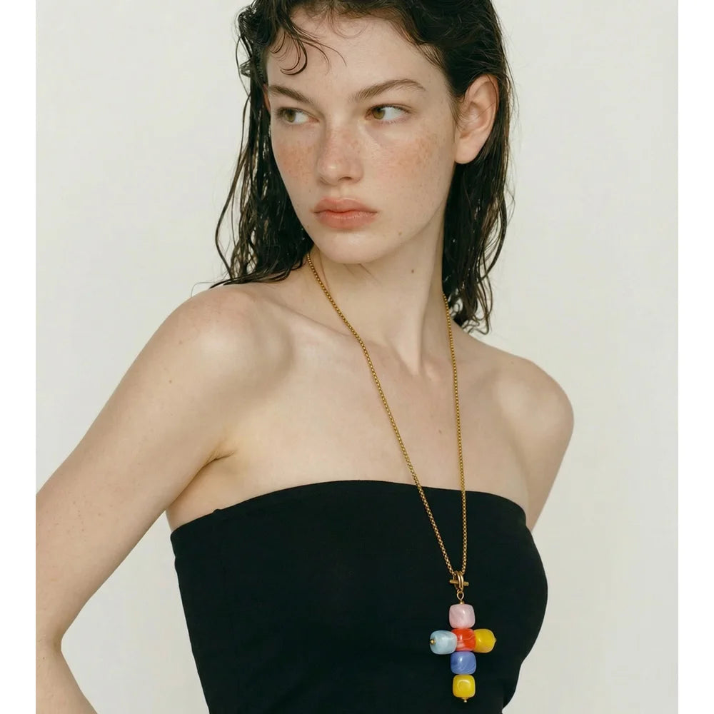 Resin acrylic cross necklace in gold-plated stainless steel with resin and acrylic.