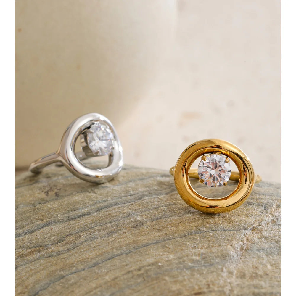 Cubic zirconia geometric ring in 18K gold-plated stainless steel with cubic zirconia.