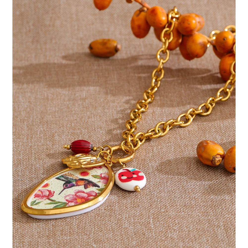 Cubic zirconia resin flower necklace in gold-plated stainless steel with cubic zirconia and resin.