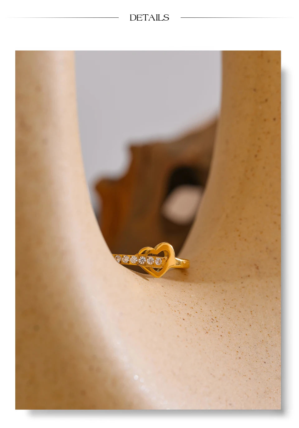 Cubic zirconia heart cross ring in 18K gold-plated stainless steel with cubic zirconia.