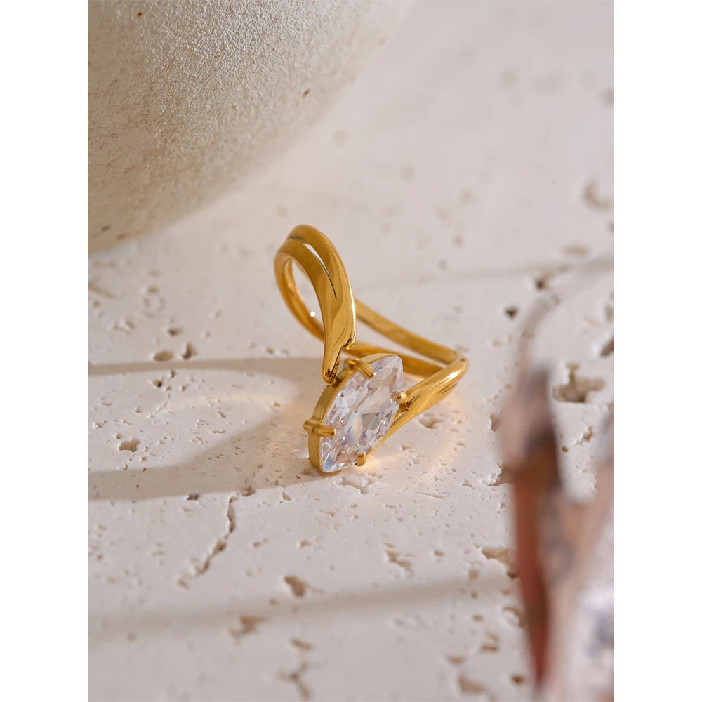 Cubic zirconia geometric ring in 18K gold-plated stainless steel with cubic zirconia.