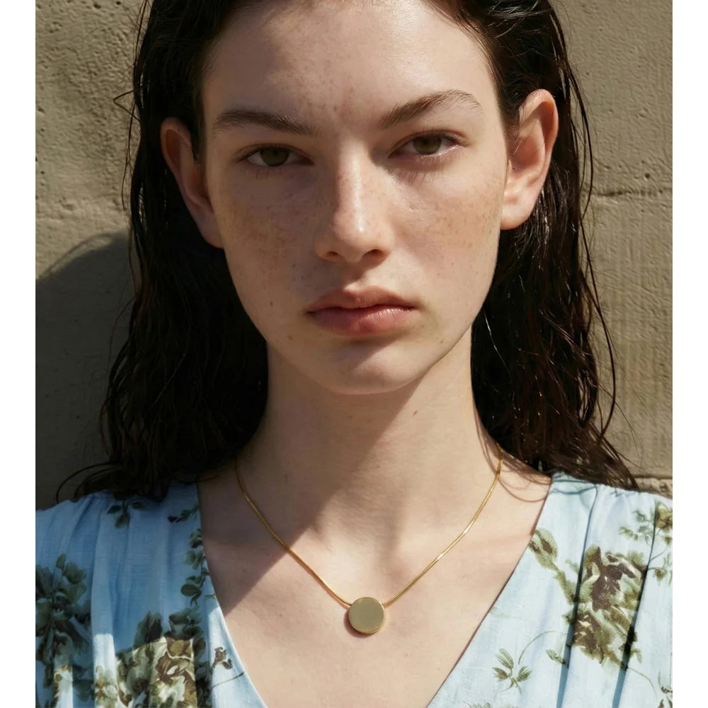 Coin geometric necklace in gold-plated stainless steel.