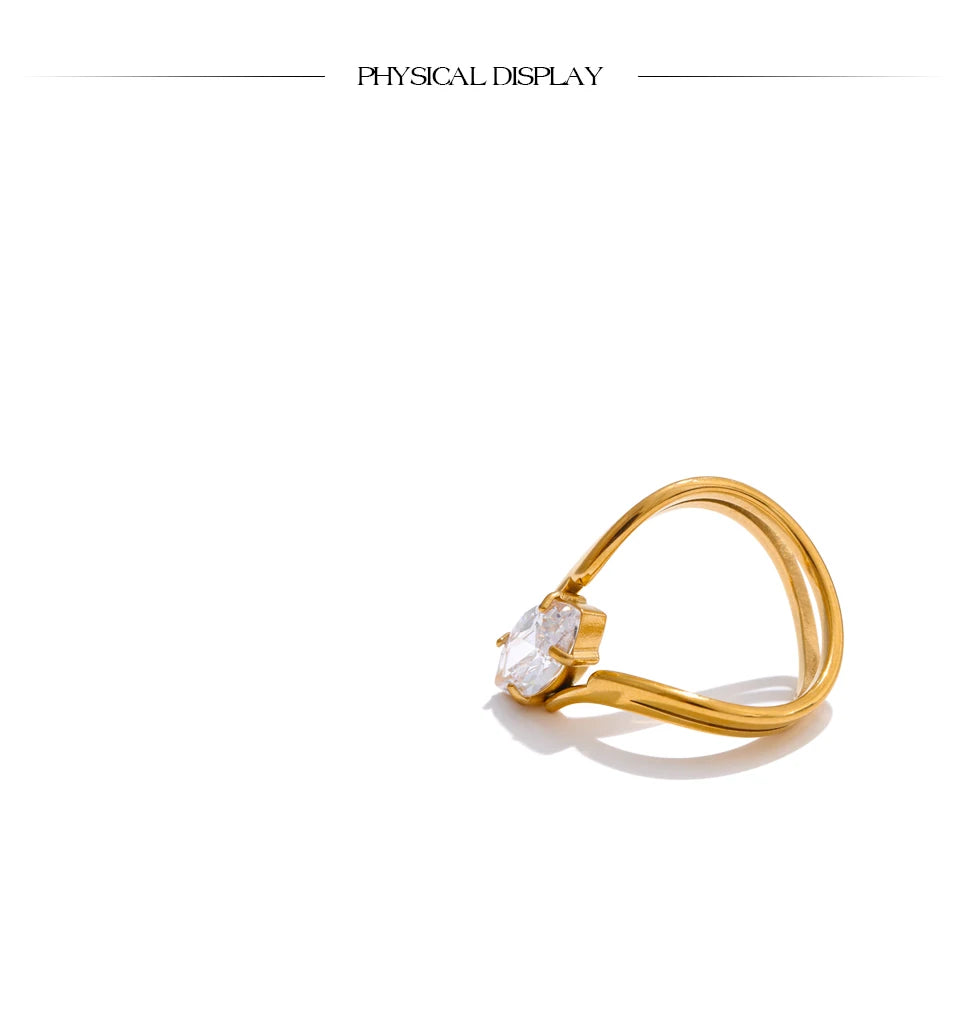 Cubic zirconia geometric ring in 18K gold-plated stainless steel with cubic zirconia.