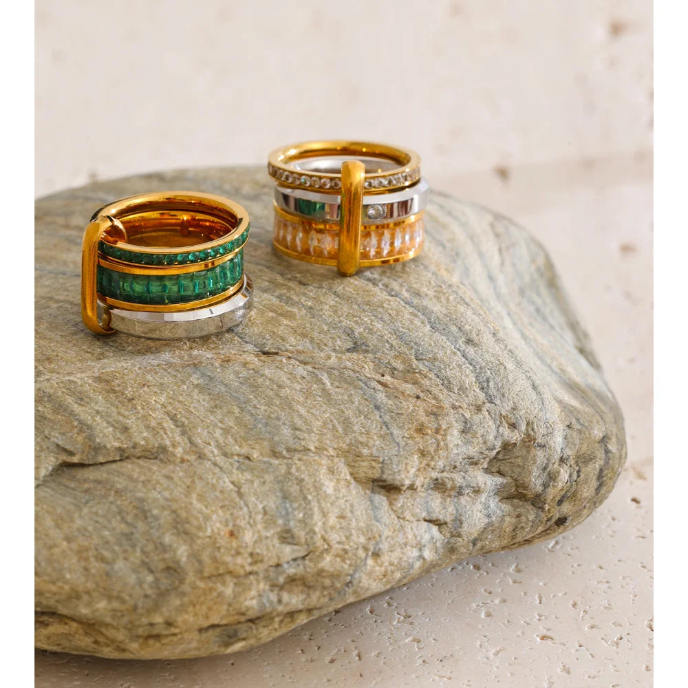 Cubic zirconia geometric layered ring in 18K gold-plated stainless steel with cubic zirconia.