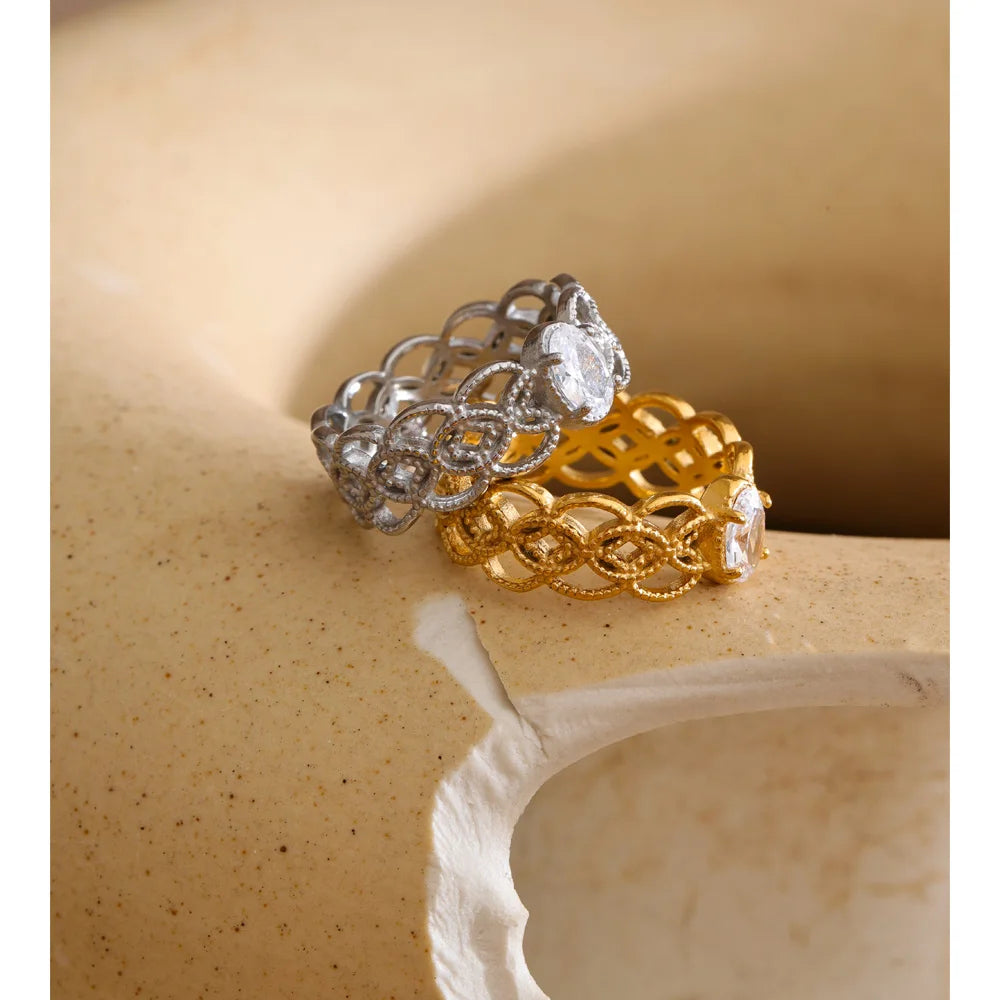 Cubic zirconia geometric ring in 18K gold-plated stainless steel with cubic zirconia.