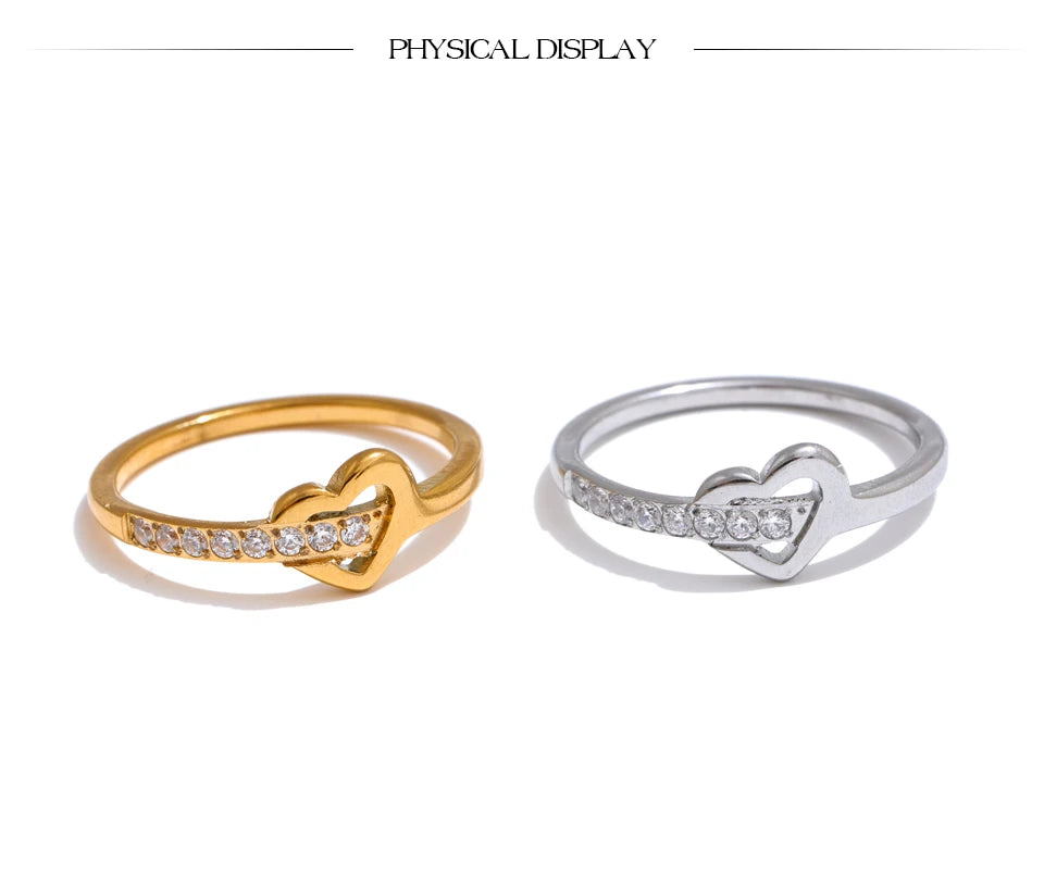 Cubic zirconia heart cross ring in 18K gold-plated stainless steel with cubic zirconia.
