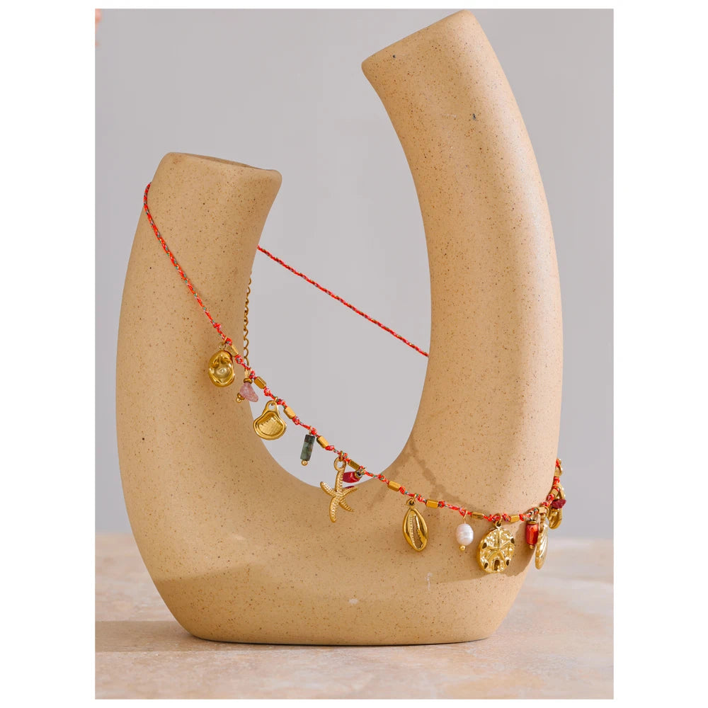 Shell natural stone star necklace in gold-plated stainless steel with natural stone and shell.