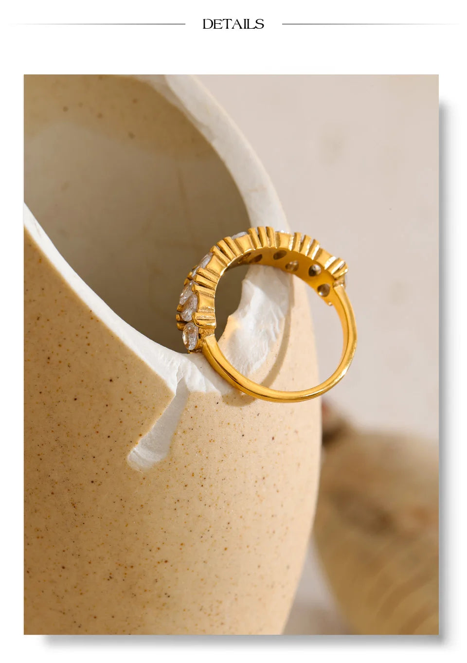Cubic zirconia geometric ring in 18K gold-plated stainless steel with cubic zirconia.