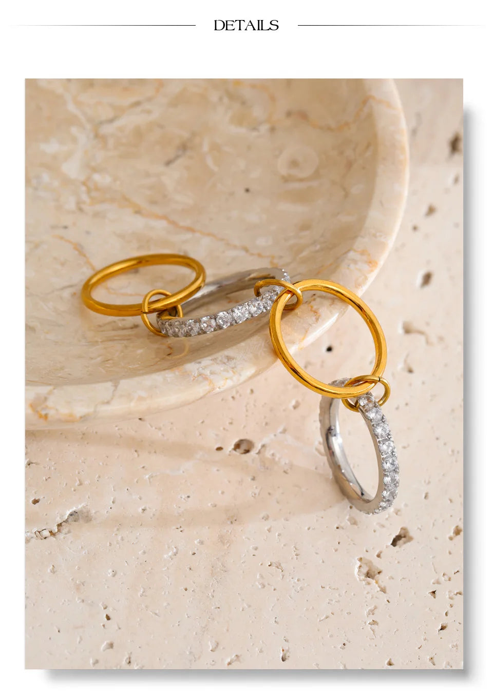 Cubic zirconia geometric layered ring in 18K gold-plated stainless steel with cubic zirconia.