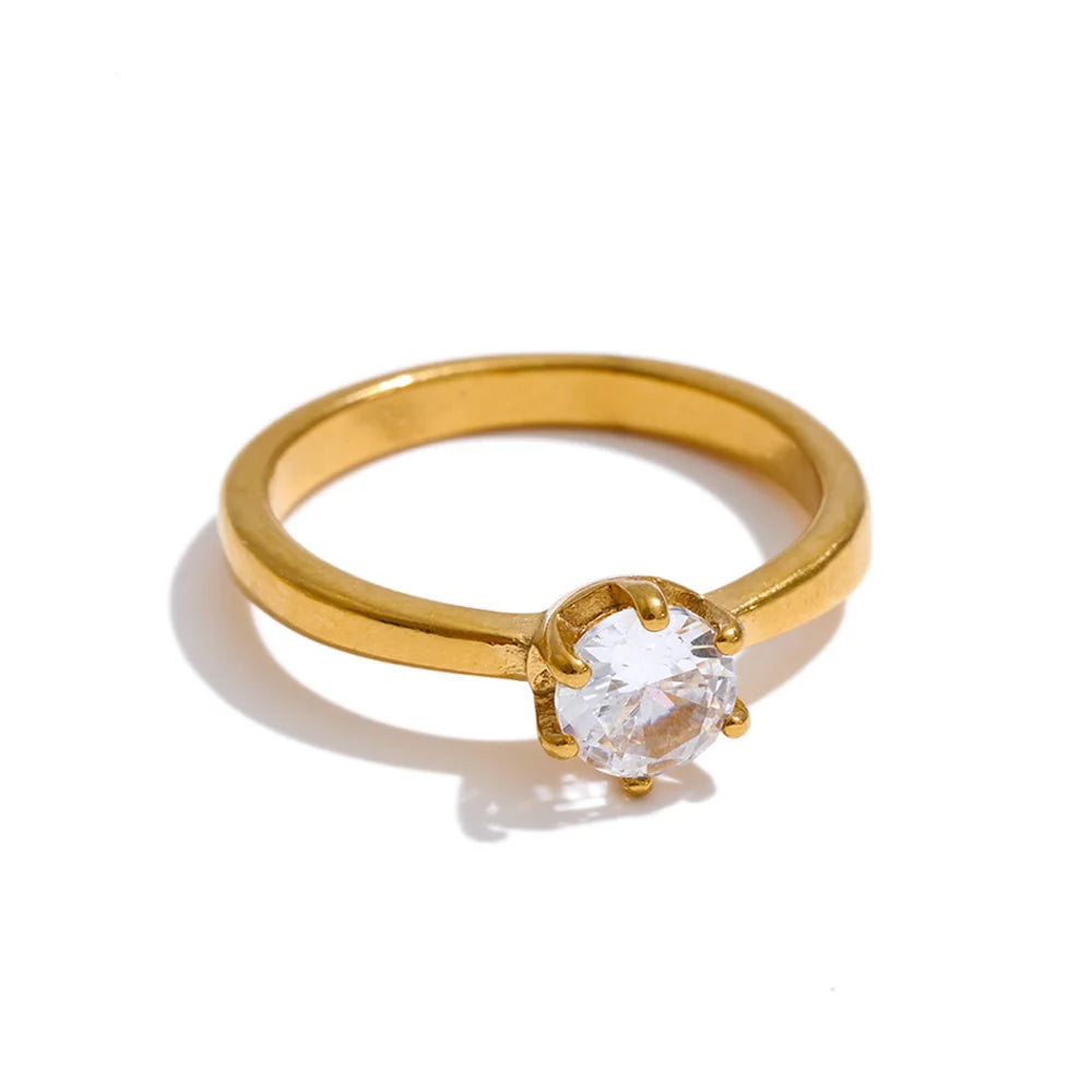 Cubic zirconia geometric ring in 18K gold-plated stainless steel with cubic zirconia.